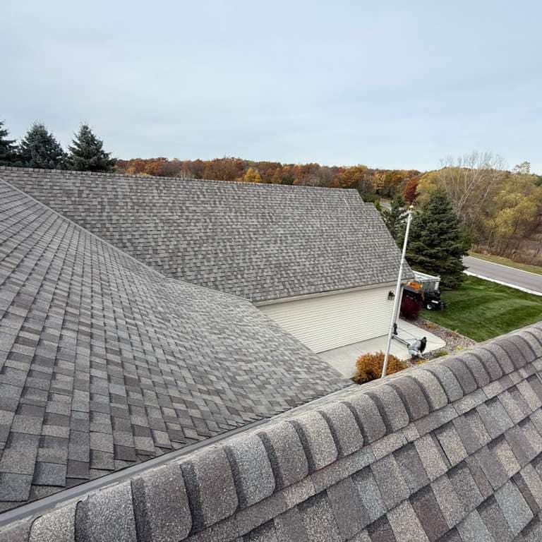 Finished shingle roof with a new ridge cap over the garage